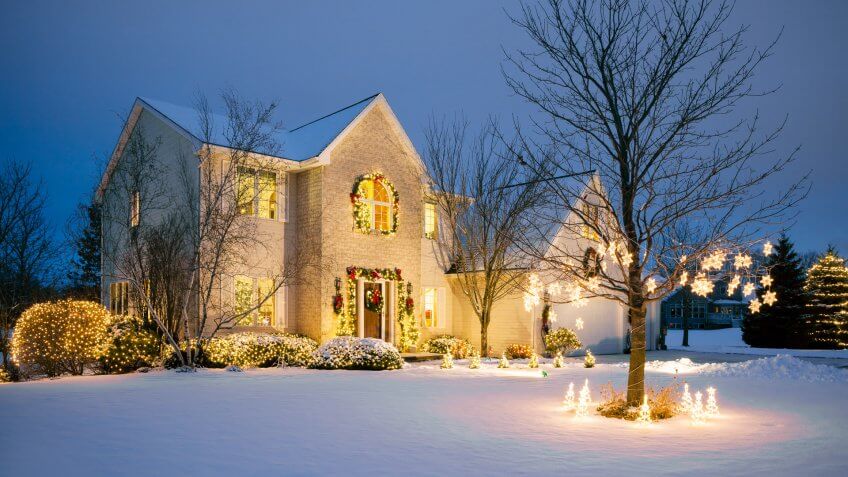 Christmas decorated home with holiday lighting, snow.