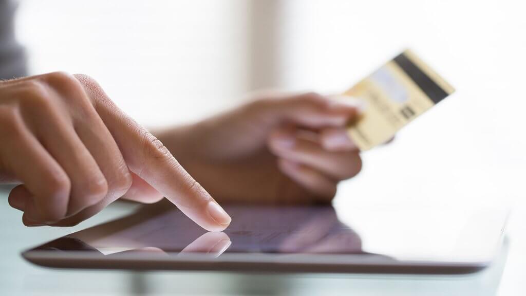 Make Payments on Time person entering credit card info into tablet