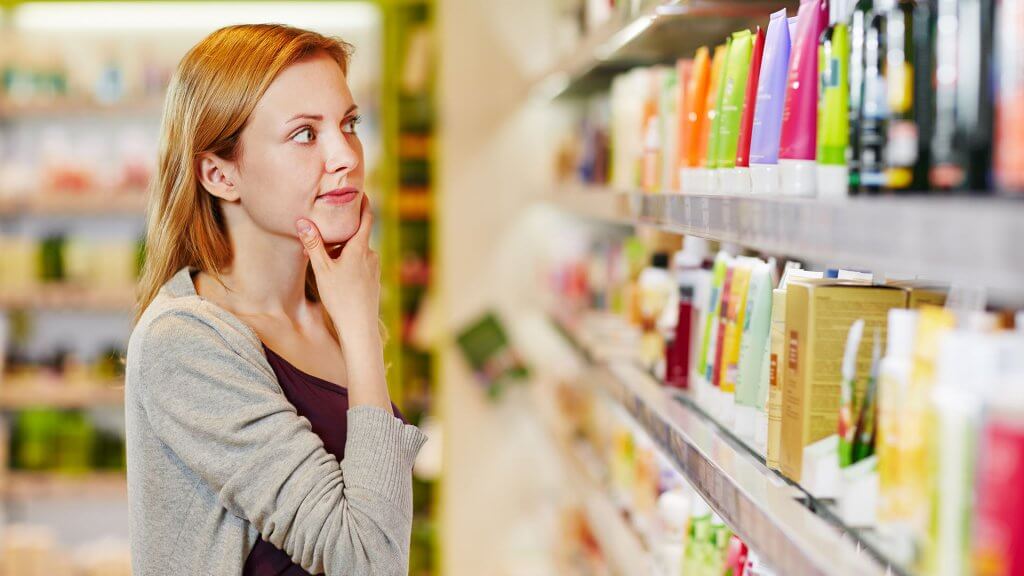 Impulse Buys. woman deciding on which product to buy in store