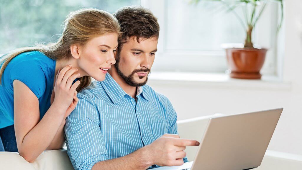 Watch Out for Scams couple looking at laptop