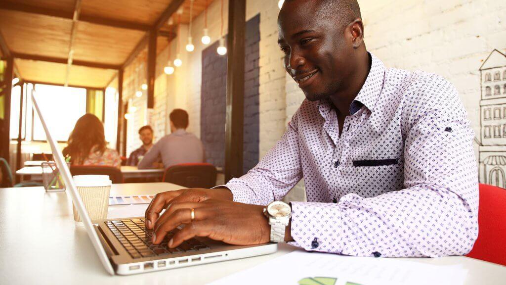 man on laptop in coffee shop