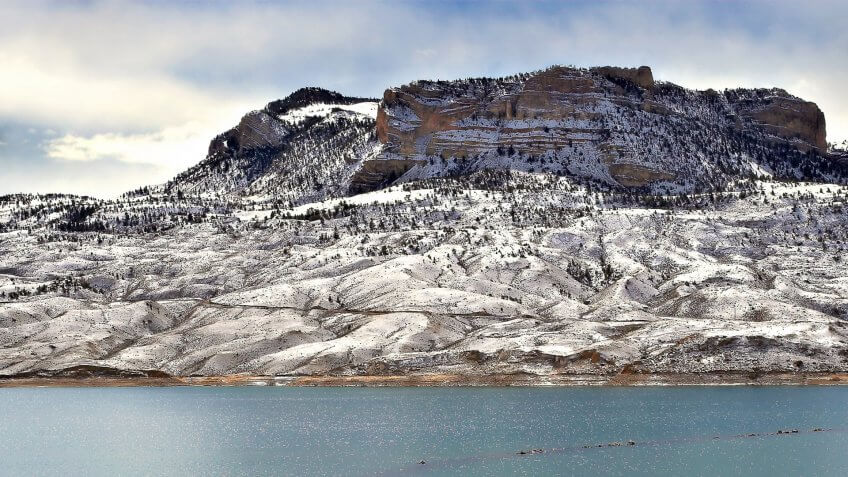 a lonesome fisherman on bufallo bill reservoir, just outside of cody, wyoming.