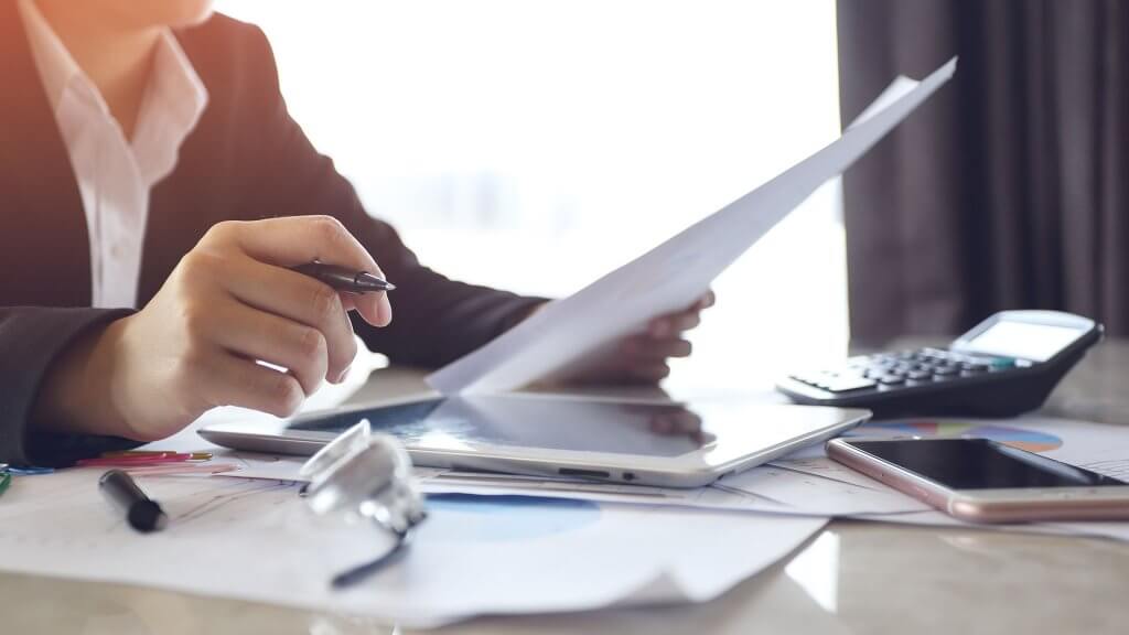 Monitor Your Credit Report businesswoman working at her desk