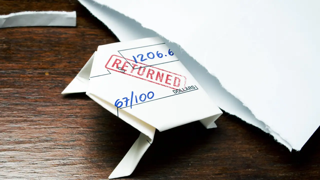 returned check folded into origami