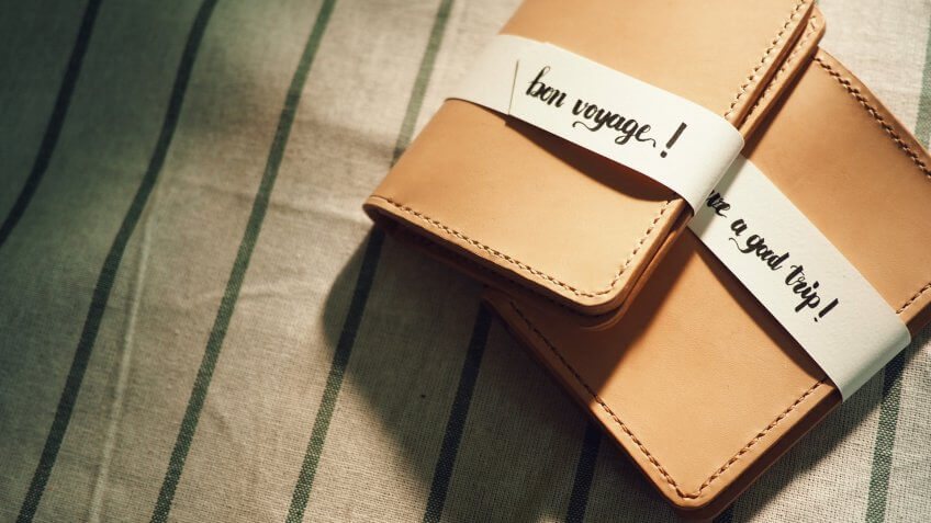 the hand crafted passport leather case with the tag 'bon voyage','have a good trip'.