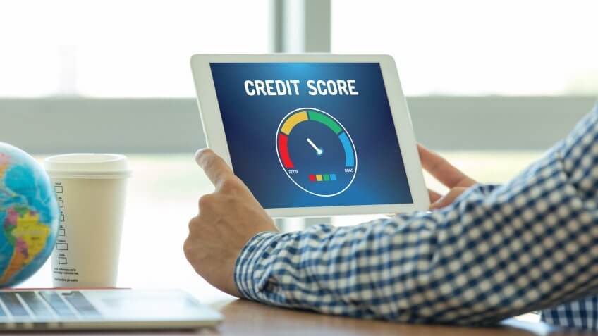 man looking at credit score on tablet