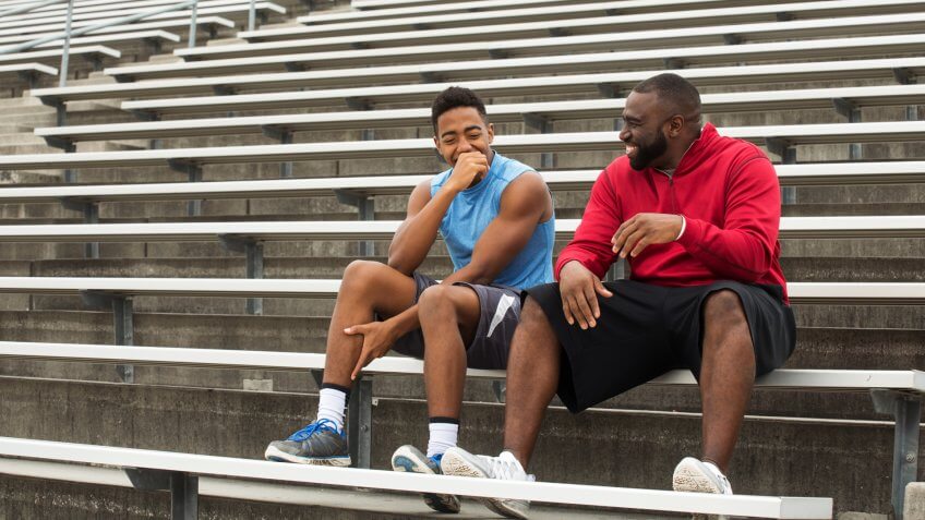 Coach spending time mentoring a student athlete.