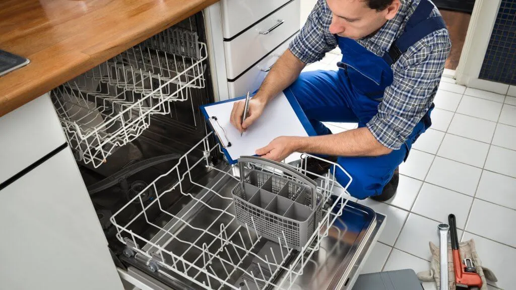 plumber inspecting dishwasher