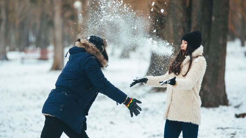 guy and girl playing in snow