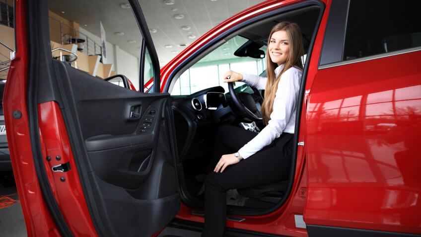 woman in red car