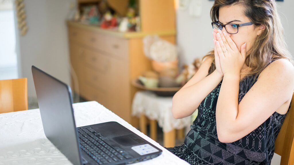 Shock Yourself shocked woman looking at something on laptop