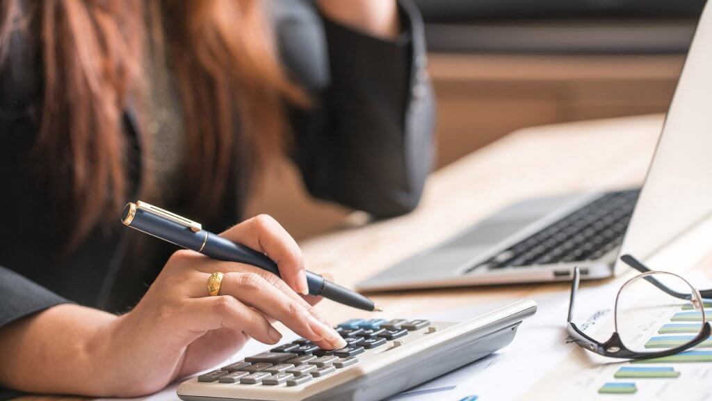 close up of woman'''''s hand using calculator