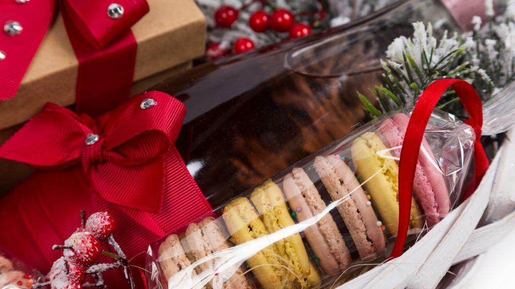 macarons wrapped in plastic and bundled in a christmas basket