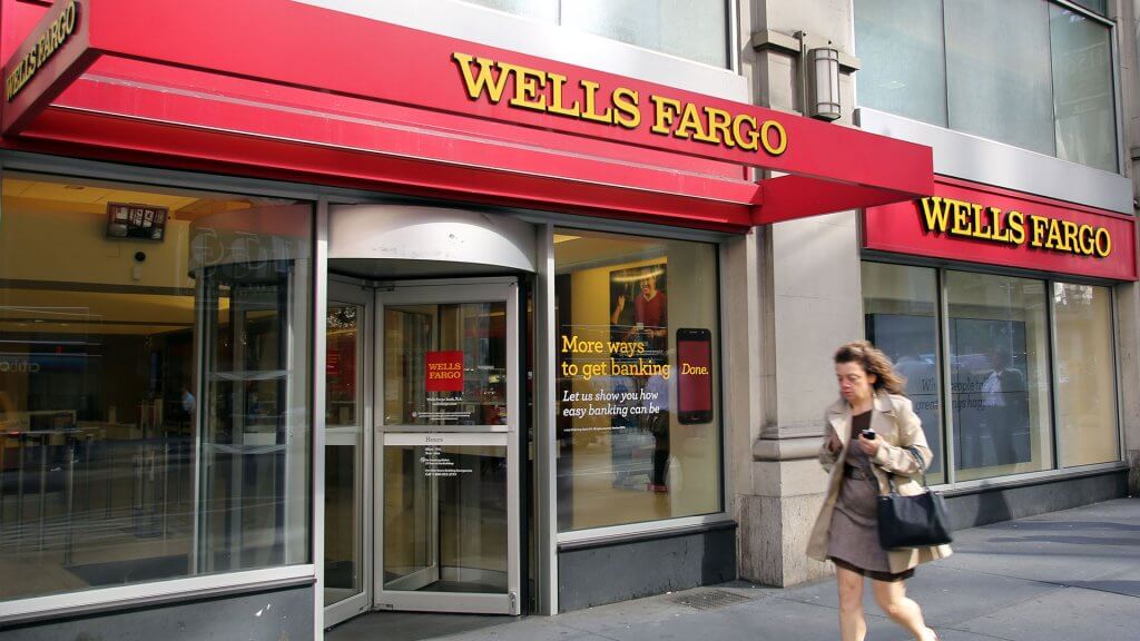 Wells Fargo Opens Unauthorized Accounts woman walking past a wells fargo bank