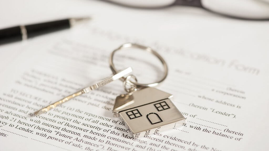 Reduce Your Biggest Debt First silver key and house keychain