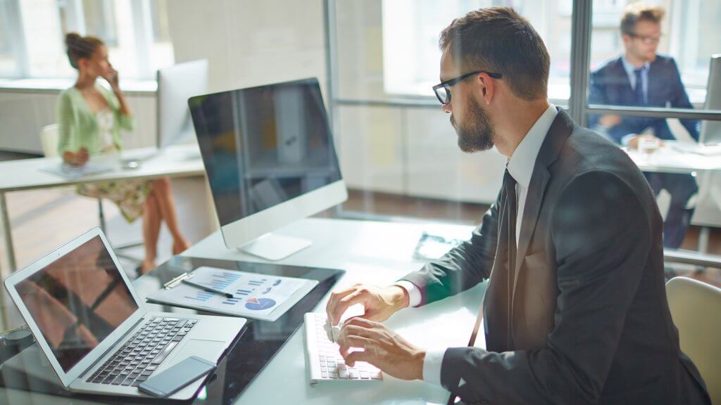 Consider Working More Hours Next Year businessman working at his office desk