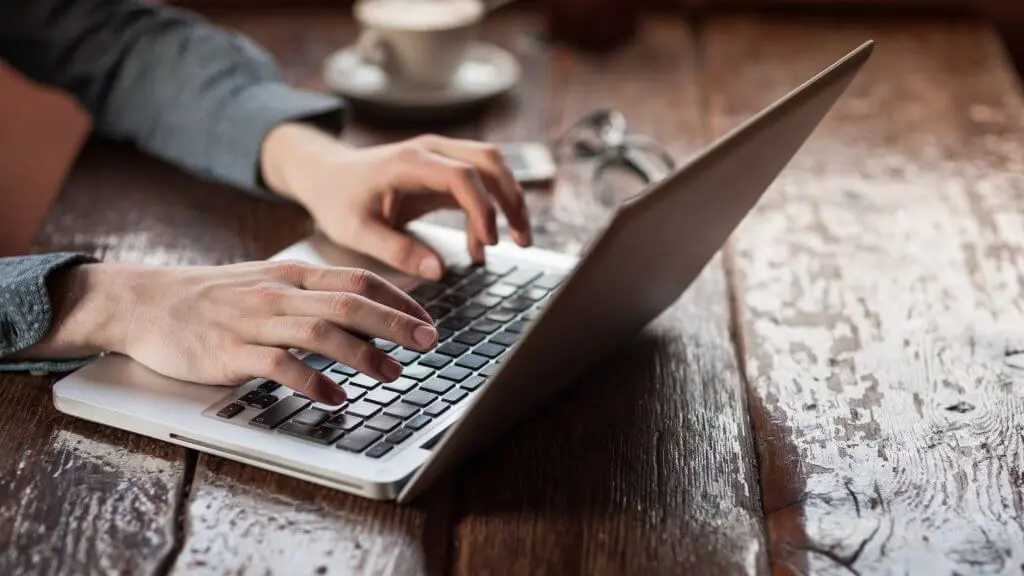 person typing on laptop
