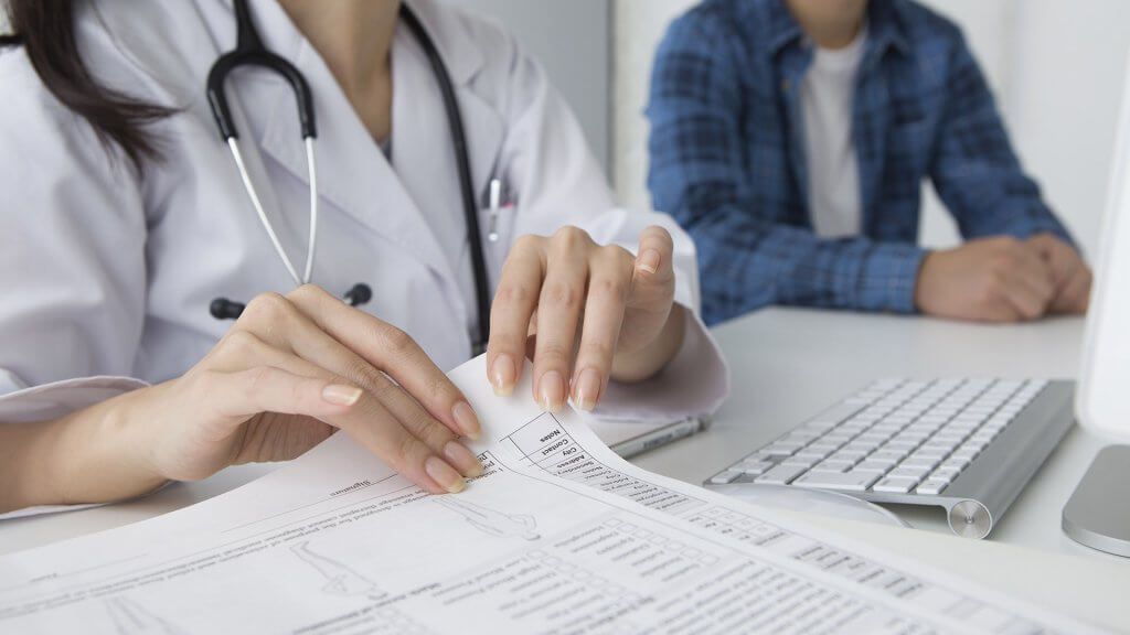 Dont Undervalue Benefits doctor flipping through paperwork