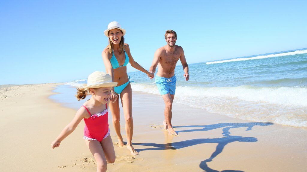 Search for Affordable Beach Vacations family of three on beach