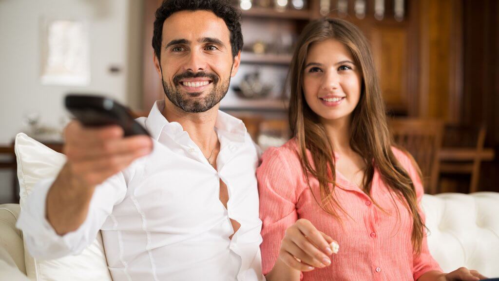 Distinguish Needs From Wants couple watching tv together