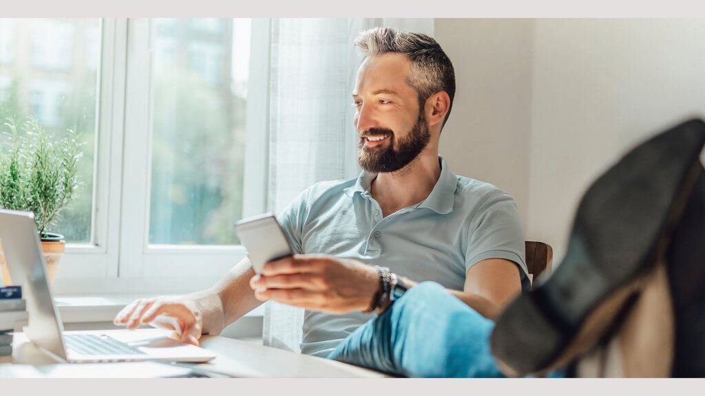 Month 5 Research Car Values handsome older man using conducting research on smartphone and laptop
