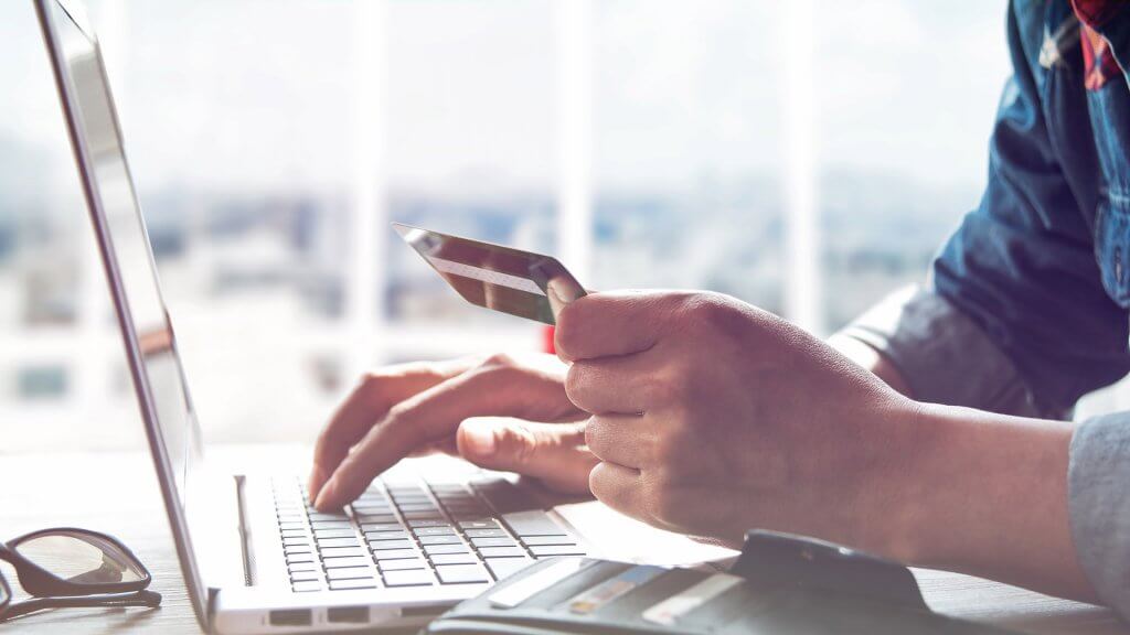 Put the Brakes on Online Shopping man entering credit card info into laptop