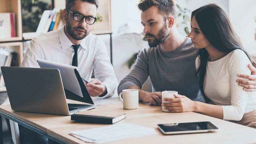 couple looking over finances with advisor