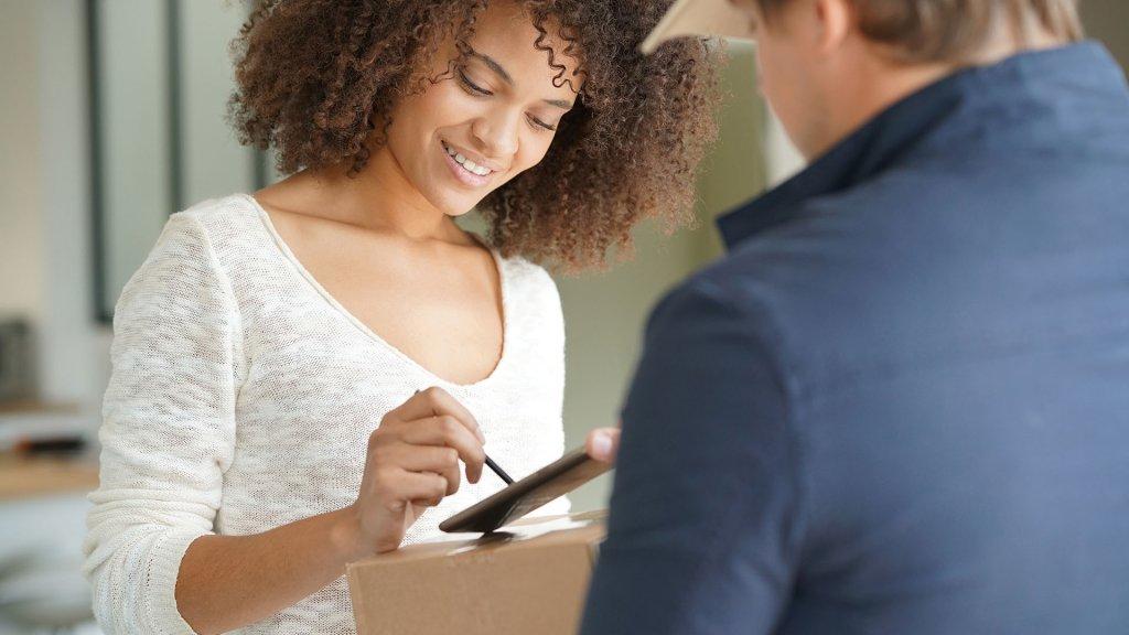 woman signing for package
