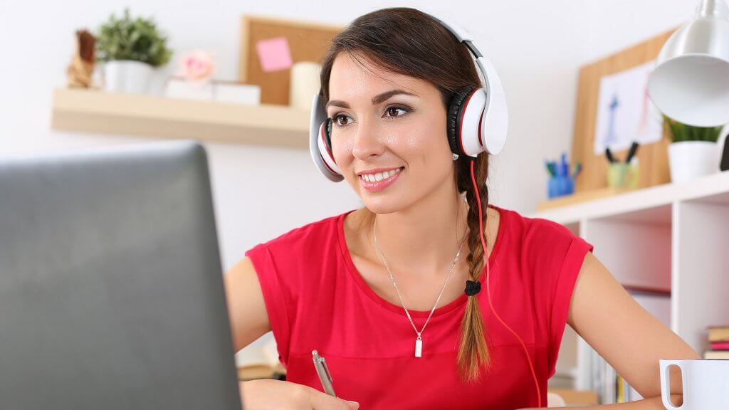 Invest in Yourself woman with headphones on computer