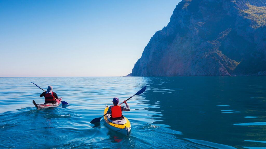 Spend It on an Experience kayakers on the ocean