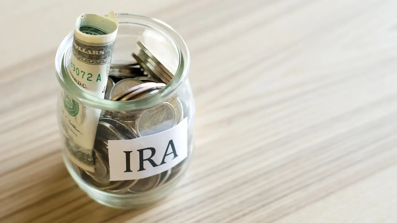 glass full of cash and change concept of IRA