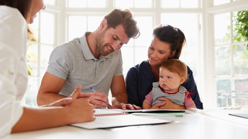Family With Baby Meeting Financial Advisor At Home.