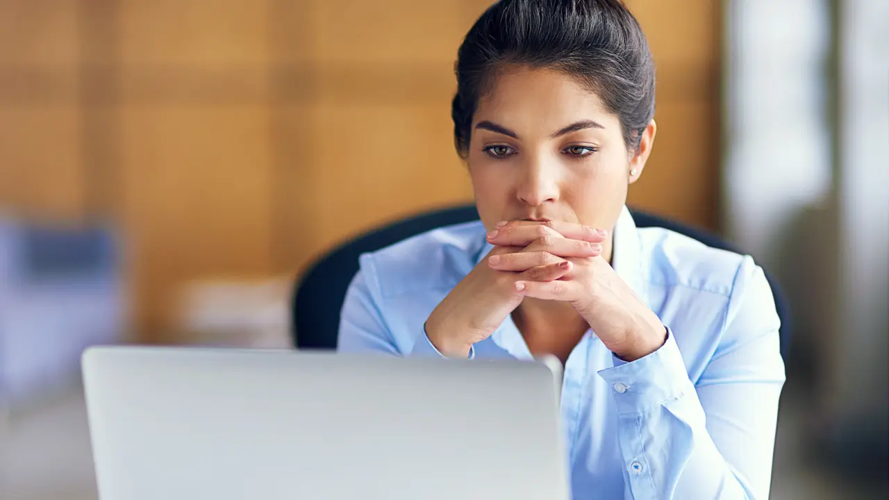 Shot of a young businesswoman looking stressed while working at her deskhttp://195.