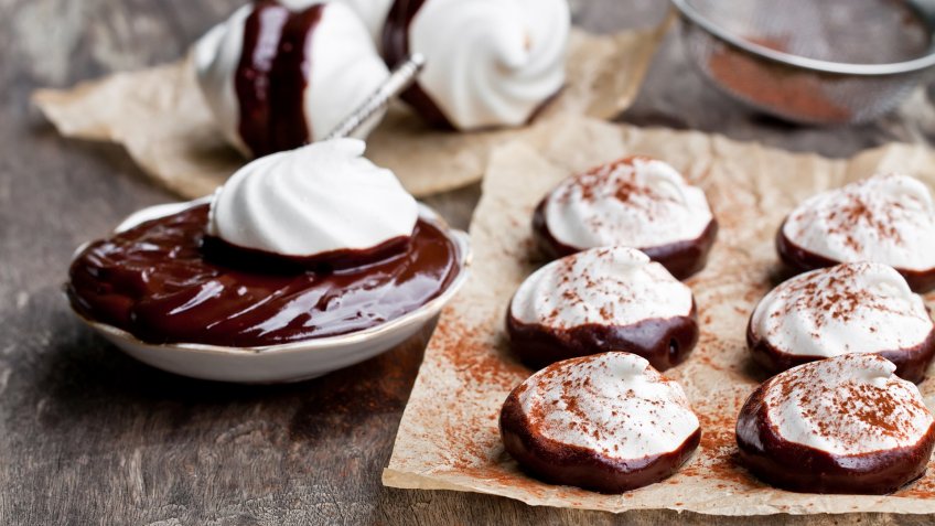 Homemade white meringues with dark chocolate.