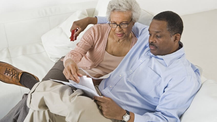 senior couple looking at bills