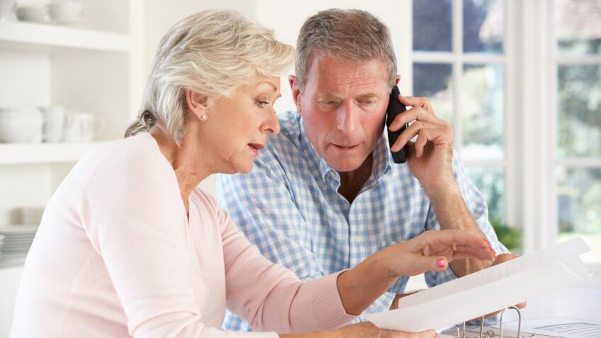 Retired couple with household bills.