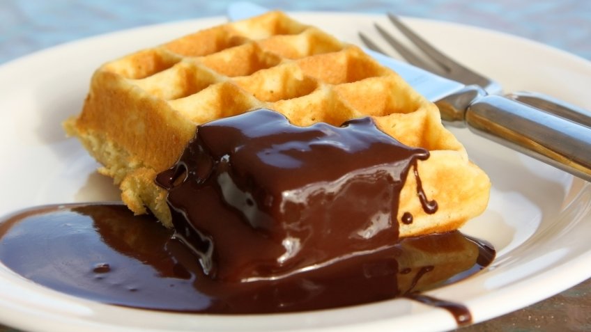 Belgian waffle with chocolate cream on the plate.