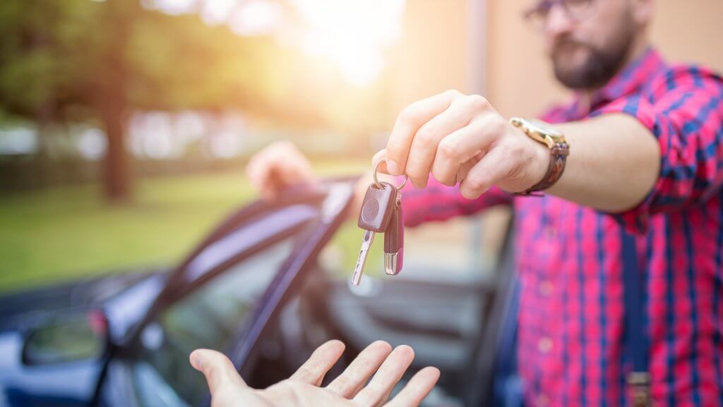 Focusing on Big Wins Is More Important Man standing by the car and giving back car keys