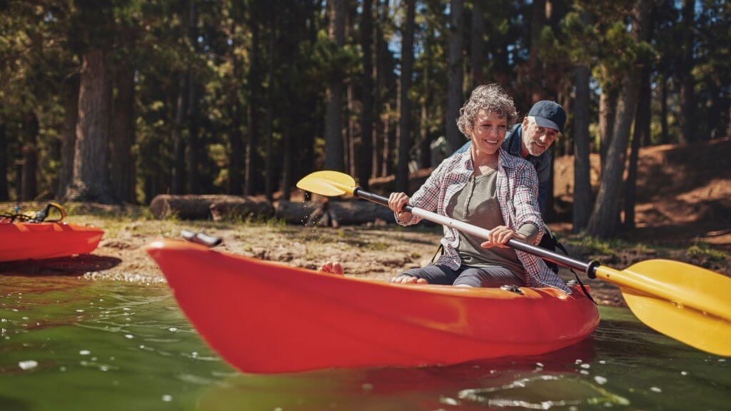 Its Equally Important to Live for Today Woman rowing in kayak with help from man