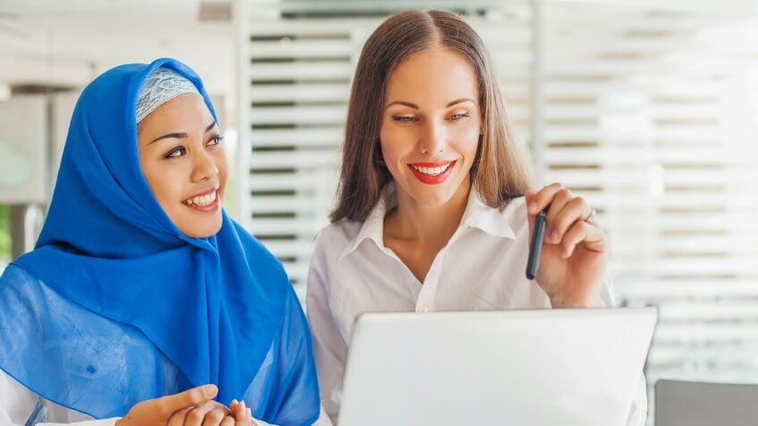 muslim woman speaking with another woman