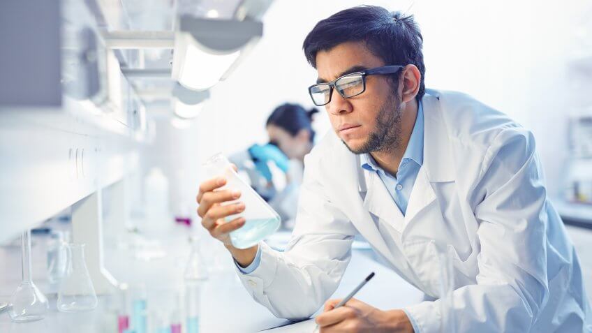 man in lab coat conducting tests