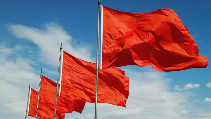 A row of red flags blowing in the wind