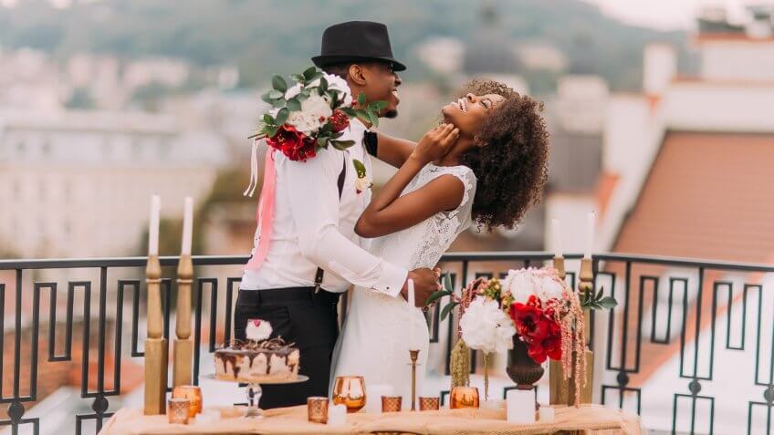 bride and groom posing outside