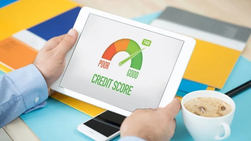 Man looking at his smart tablet showing his god credit score