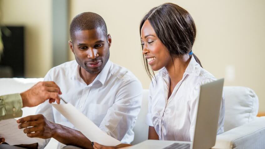 Couple talking to their financial advisor.