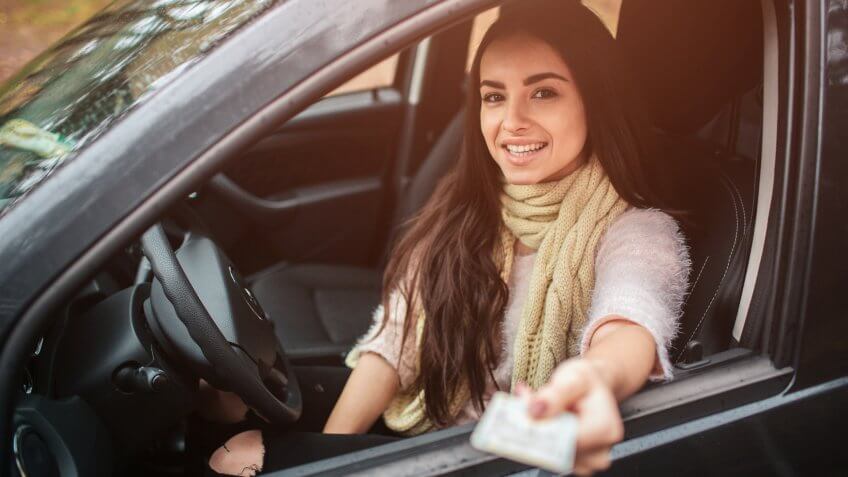Woman showing driving license.