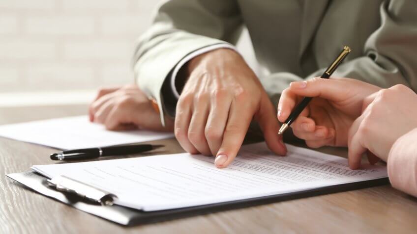 Human hands working with documents at the desk closeup.