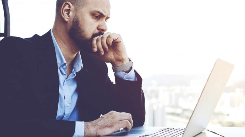 Businessman looking concerned with results of last meeting with investors.