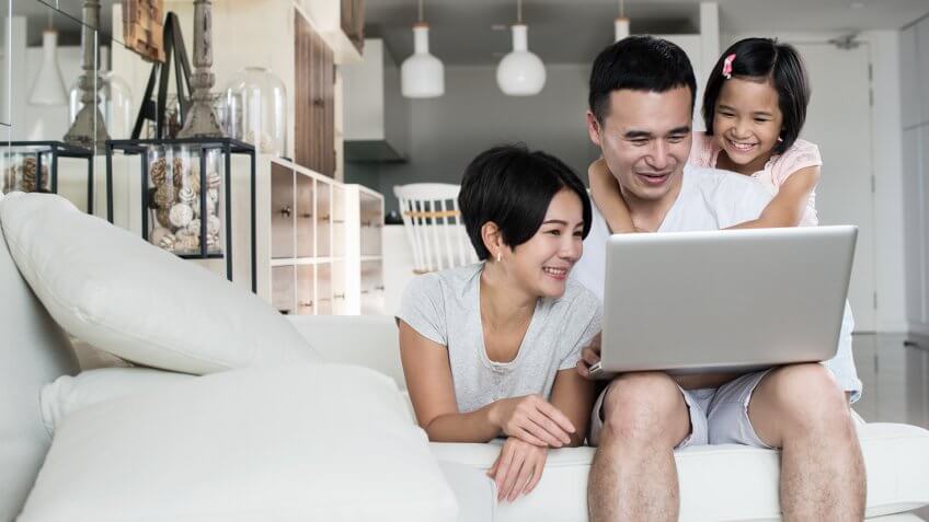 Happy Asian family spending time together at home.