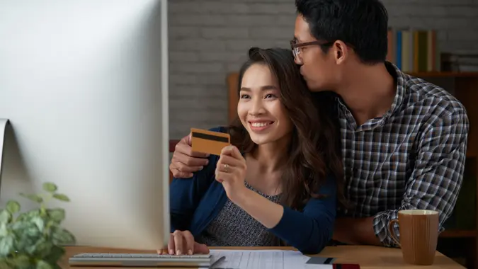 Young couple making online purchases at home.